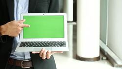 Businessman Showing Laptop with Green screen display,Chroma key Stock Footage