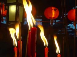 CU Shot of Worshiper candles, incense and lanterns in evening Man Mo Temple / Hong Kong, Special Administrative Region, China  Stock Footage