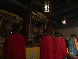 Priests kneel at an altar in the Bai Yun Guan Temple, Beijing. Stock Footage