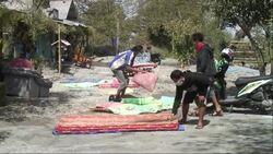 Residents clean up as volcano continues to spew smoke Instructional Video