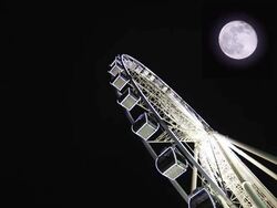 Ferris Wheel in Night Sky with full moon Stock Footage