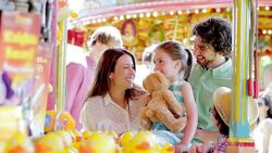 Family winning prize at amusement park Stock Footage