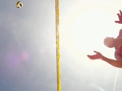 POV LA WS of female beach volleyball players spiking and blocking at the net with sun. Stock Footage
