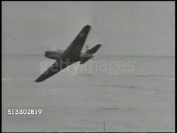 1942: BATTLE OF MIDWAY:  VS U.S. Navy Douglas SBD Dauntless dive bomber flying by over Midway Island air base. XWS U.S. carrier at sea off coast. VS Fighter aircraft approaching for landing on flight deck, landing. World War II, WWII, Pacific Front Instructional Video