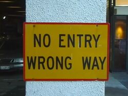 Blocked: 'No Entry. Wrong Way' Road Sign on Concrete Post Stock Footage