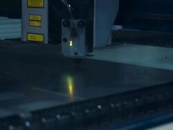 Push in on close up of laser cutting holes in a sheet of metal. Stock Footage