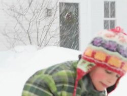 CU TU TD Boy smiling and eating snow during snow storm / Yarmouth, Maine, USA Stock Footage