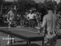 1952: LAS VEGAS, NEVADA: PING PONG: Angled WS Two teenage males dressed in shorts & no shirts playing ping pong on table outdoors w/ senior male watching.   Game, paddles, ball, net, amateur, sport, hand-eye coordination, fun. Instructional Video