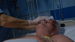 Nurse bathing the patient in intensive care Stock Footage
