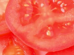 Close up of rotating fresh tomato slice Stock Footage