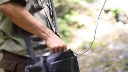 Researchers listen to the radio signal from radio telemetry,tracking to find an wildlife in tropical rainfores Stock Footage