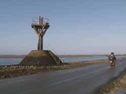 WS Vehicles passing through submersible road between french continent and Island of noirmoutier with saftey tower / Noirmoutier, Vendee, France Stock Footage