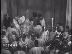 1949: CHRISTMAS EVE 'HOLY YEAR' CEREMONY: Procession walking w/ Pope Pius XII to Portia Santa (The Holy Door) & tapping interior door Cross three times w/ gold hammer (opening door for Pilgrims for jubilee), low SOT Pope Pius XII & audience response. Instructional Video