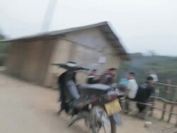 MS LA POV PAN passing people driving on dirt road / Sam Nuea, Laos Stock Footage
