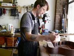 Craftsman 'Luthier' Nigel Forster making hand made Guitars Stock Footage