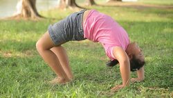 Young asian fat girl practicing yoga in the park Stock Footage