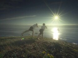MS POV TS SLO MO Couple practicing yoga overlooking Pacific Ocean / Port Orford, Oregon, United States Stock Footage