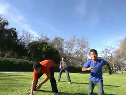 A father teaching his sons how to play American football.  - Slow Motion Stock Footage