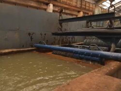 Steel Mill - Coils lifted from bath Stock Footage