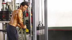 Young Men Performing Triceps Exercise inside the Gym Stock Footage
