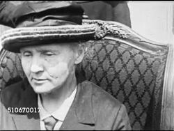 1921: SCIENCE: Physicist & chemist Marie Curie (1867-1934) sitting in chair w/ two women standing behind, CU Marie, CU Male hands holding gift box w/ glass vile holding gram of radium gift, Marie standing w/ President Harding (head cropped) Instructional Video