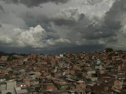 WS PAN View above rooftops woods cloudy sky with red houses / Lagos, Nigeria Stock Footage