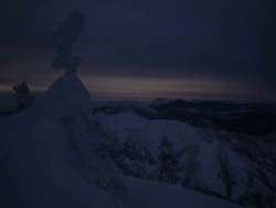 T/L sun rising over snow covered trees in the Shiga mountains, Japan Stock Footage