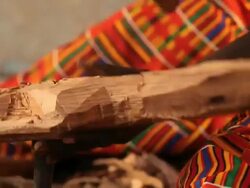 Senegalese craftsman carves wooden ormnament Stock Footage