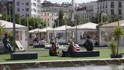 Portugal, Lisbon, Mouraria neighborhood, people sitting in Martim Monisz square Stock Footage