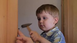 Baby using hammer Stock Footage