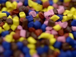 Polymer granules falling in slow motion Stock Footage