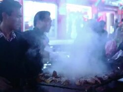 MS Shot of men preparing food on grill in restaurant / Kohima, Nagaland, India Stock Footage