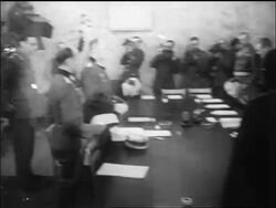 B/W May 1945 Nazi + Allied officers sit before signing surrender / newsreel Stock Footage