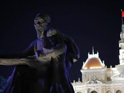 MH LD Statue of Vietnam at Night with Vietnam City Hall in Background / Vietnam Stock Footage