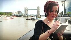 Tourist woman by the Tower Bridge in London Stock Footage