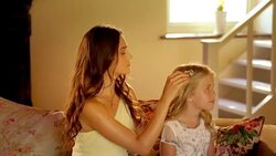 Bridesmaid fixing flower girlï¿½s hair before wedding Stock Footage