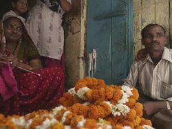 WS Woman knitting at flower vendor stall / Delhi, Delhi , India Stock Footage