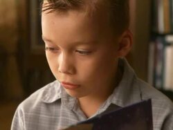 Young boy reading a book Stock Footage