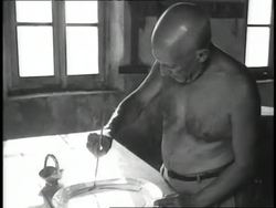 Paint steams in a pot as Pablo Picasso paints a bowl. News Clip