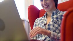 smiley young woman working with laptop at home Stock Footage