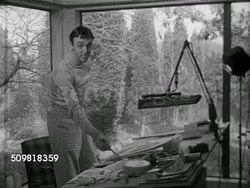 1952: AMERICAN ARTISTS: Angled WS Outside studio of Brian Connelly, Brian working at desk in studio, working on De Beers painting, SOT Saying pleased to be doing these, painting is a wonderful life, making a living doing what he likes best in world. Instructional Video
