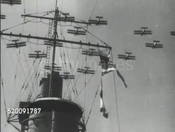 1934: UNITED STATES NAVY: *VS Convoy of warships, biplanes in flight over battleship, President Franklin D. Roosevelt w/ hat over heart standing w/ naval officers saluting, WS Aircraft carrier. Patriotic, patriotism, FDR speech over. Instructional Video