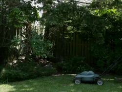 Man mowing grass with lawnmower Stock Footage