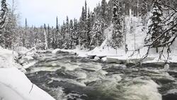 Fast flowing river winter snow Juuma Oulanka Nat Pk Finland slow motion Stock Footage