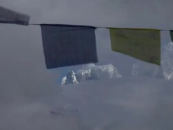 AERIAL CU PAN Looking towards snow filled mountain and Prayer flags blowing in foreground / Namche,Namche Valley,Nepal Stock Footage