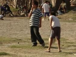 MS Shot of boy playing bouncing football with hand / Buenos Aires, Argentina Stock Footage