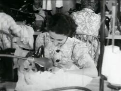 B/W 1934 woman using sewing machine in WPA garment factory / documentary Stock Footage