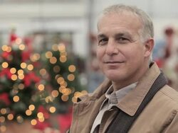 Mature man in garden centre, turning to look at camera Stock Footage