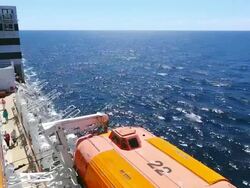 MS Side POV View of Cruise ship Queen Mary 2 of Cunard Line with small boat / North Sea, Jutland, Denmark Stock Footage