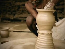 Indian potterâ€™s skilled hand shaping pot on manual pottery wheel Stock Footage